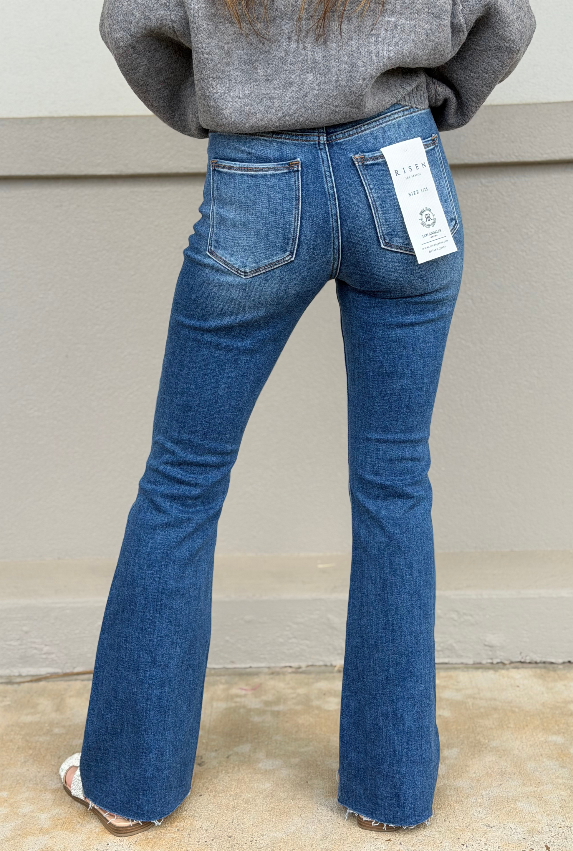 HIGH RISE FLARE JEANS WITH RAW CUT HEM JEANS